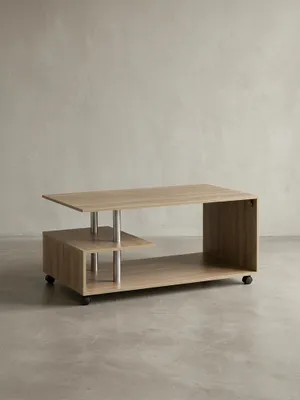 Moderner Couchtisch auf weißem Hintergrund in der Frontansicht. Das 105x60cm große Möbelstück besticht durch helle Eichenoptik, klare Linien und praktische Rollen für das Wohnzimmer._#sku_BARWL5.735#