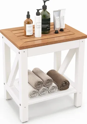 A white and wood bathroom stool with towels on the shelf and toiletries on top.