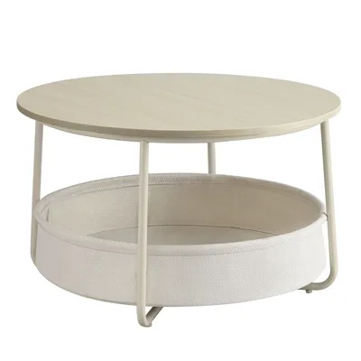 A round coffee table with a fabric storage basket underneath.