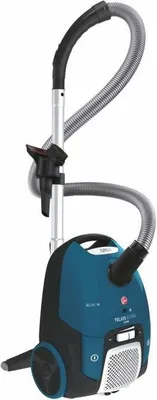 A studio product shot of a blue and black Hoover vacuum cleaner.