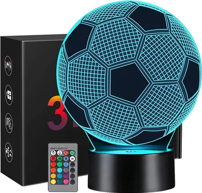 A 3D soccer ball night light with a remote control and packaging in the background.
