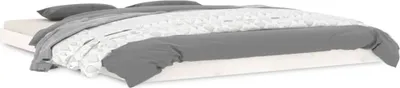 A bed with gray and white bedding, shown from a side angle.