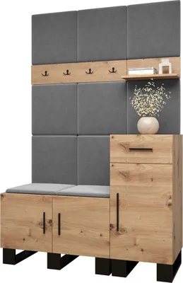A modern hallway storage unit with upholstered panels, coat hooks, a shelf, a drawer, and cabinet doors.