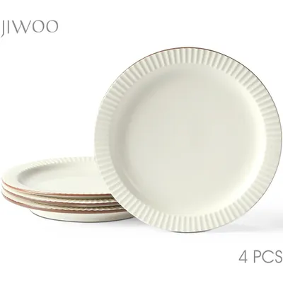 A stack of four white ceramic plates with a ribbed edge and a thin brown rim, with one plate prominently displayed in the foreground.