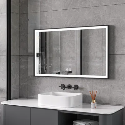 A modern bathroom with a sink, faucet, and a lighted mirror.