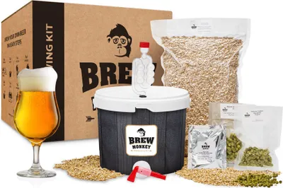A beer brewing kit with ingredients and a glass of beer.