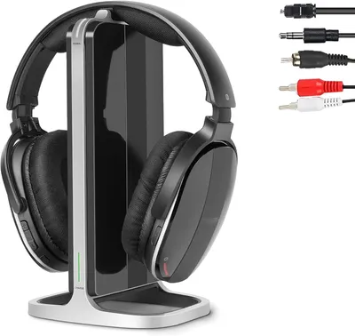 A pair of wireless headphones and their charging stand are displayed on a white background, with various audio cables shown to the right.