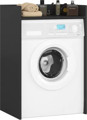 A white washing machine is shown in front of a dark gray cabinet.