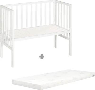 A white crib and a white mattress are shown against a white background, with a plus sign in between them.