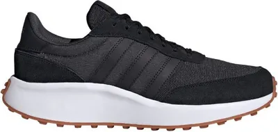 A side view of a black Adidas sneaker with a white sole and brown outsole.