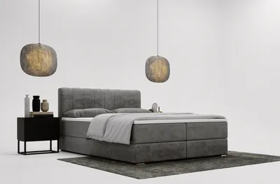 A modern bedroom setup with a boxspring bed, nightstand, and pendant lights.