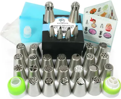 A set of cake decorating nozzles and accessories laid out on a white background.