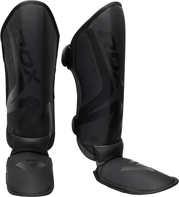 Produktbild von RDX Schienbeinschoner Kickboxen, NOIR Schienbeinschützer Thaiboxen Kampfsport Muay Thai MMA Spannschützer, Maya Hide Leder, Schienbeinschutz Polster Shin Guard Sparring Beinschutz Herren Damen Schwarz