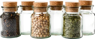 A set of six small glass jars with cork stoppers, some filled with spices or grains.