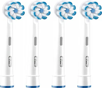 Four white Oral-B electric toothbrush heads with blue and white bristles are lined up against a white background.