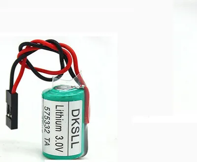 A close-up of a green lithium battery with red and black wires and a black connector.