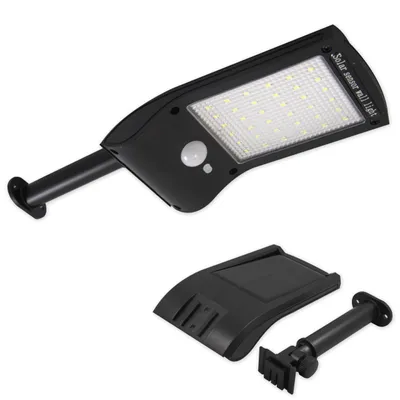 A black solar wall light with its mounting accessories is displayed against a white background.
