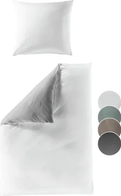 A white pillow and a white duvet cover are shown against a white background. Several colored circles are displayed to the right of the duvet cover.