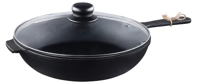A black cast iron pan with a glass lid is shown on a white background.