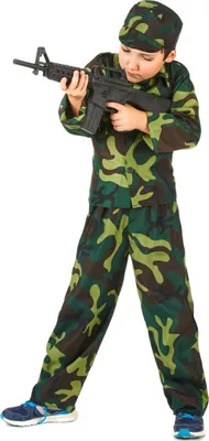 A young boy dressed in a camouflage military costume, holding a toy rifle.