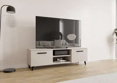 A modern TV stand with a television on top, placed in a living room setting with a floor lamp.