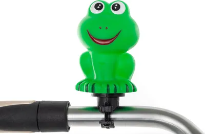 A green frog-shaped bicycle bell attached to a handlebar.