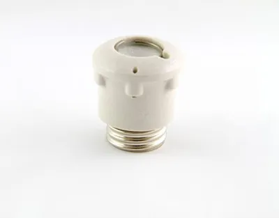 A white ceramic fuse holder with a silver threaded base is shown against a white background.