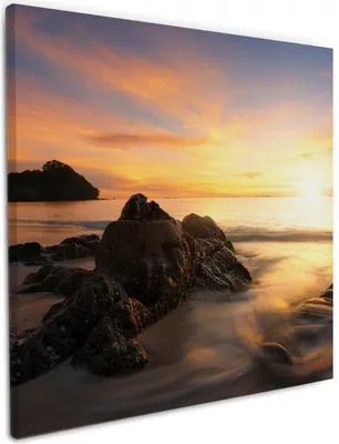 Produktbild von Wallario Premium Leinwandbild Sonne über dem Meer mit Felsenlandschaft in Größe 50 x 50 cm