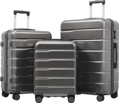Three gray suitcases of different sizes are arranged diagonally on a white background.