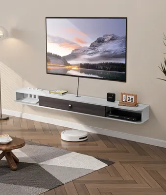 A modern living room with a wall-mounted TV cabinet and a TV.