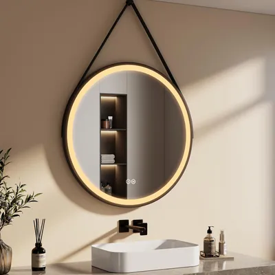 A modern bathroom scene featuring a round LED mirror above a sink.