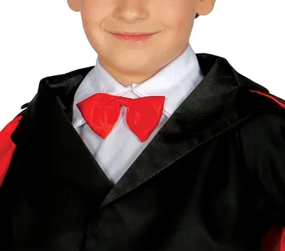 Close-up of a child wearing a magician's costume, featuring a black jacket with red trim, a white shirt, and a red bow tie.