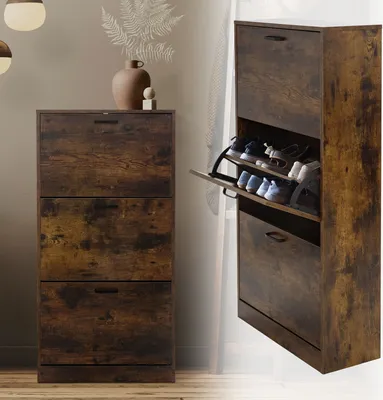 A shoe cabinet with three flip drawers is shown in a room with a light gray wall and wooden floor.