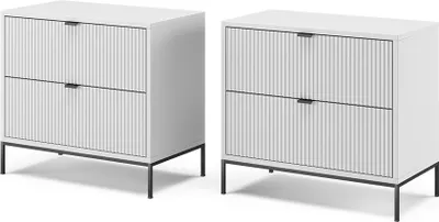 Two white bedside tables with fluted drawers and black metal legs are shown against a white background.