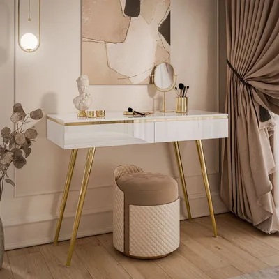 A modern vanity set with a white console table and a beige upholstered stool, decorated with a bust and makeup brushes.