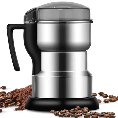 A stainless steel coffee grinder with a black handle and lid, surrounded by coffee beans and ground coffee.