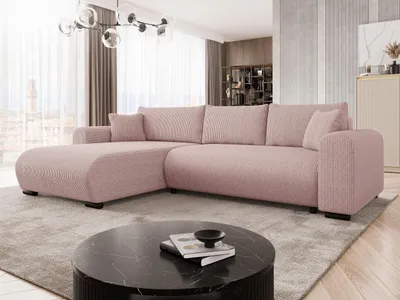 A modern living room with a pink sectional sofa, a black coffee table, and a chandelier.