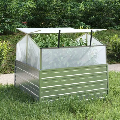 A raised garden bed with a greenhouse cover, filled with plants, sits on a grassy lawn.