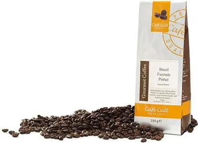 A bag of coffee beans and loose coffee beans on a white background.