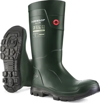 A pair of green Dunlop safety boots, with one boot shown upright and the other sole-up.