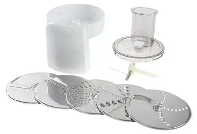 A set of food processor attachments, including various cutting discs and a pusher, laid out on a white background.