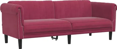 A studio shot of a burgundy velvet sofa.