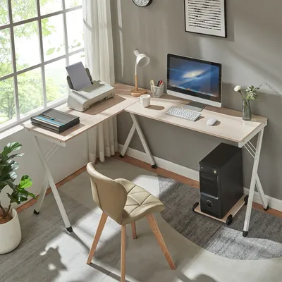 A home office setup with an L-shaped desk, computer, printer, and chair.