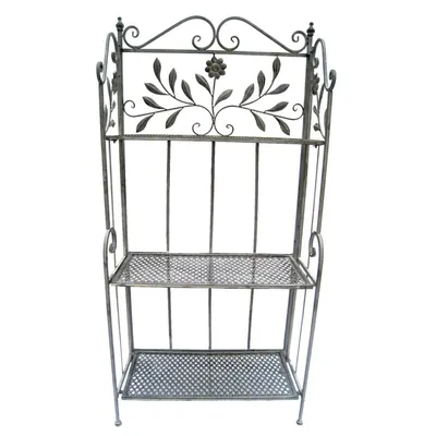 A metal baker's rack with decorative scrollwork and floral accents.