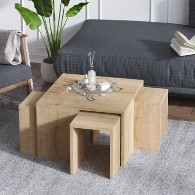 A living room scene with a nesting coffee table set, a sofa, and a chair.