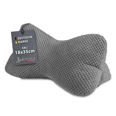A grey bone-shaped pillow with a tag attached.