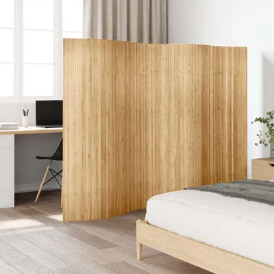 A room divider made of bamboo is placed between a bedroom area and a workspace.