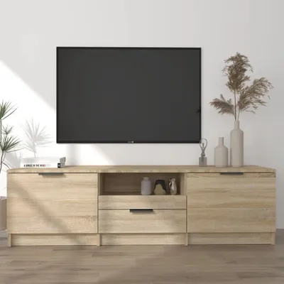 A TV stand with a television mounted above it, in a room with a white wall and wooden floor.