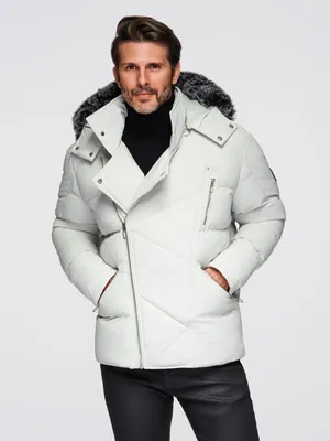 A man wearing a white winter jacket and black pants, posing against a white background.