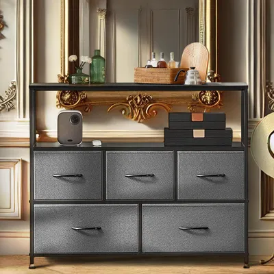 A dresser with five drawers is shown in a room with ornate gold trim and a mirror in the background.